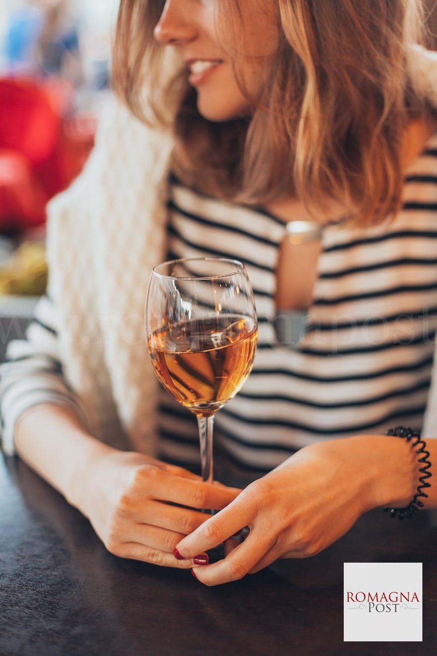 woman holding glass of wine