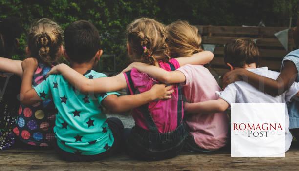 Group of kindergarten kids friends arm around sitting together